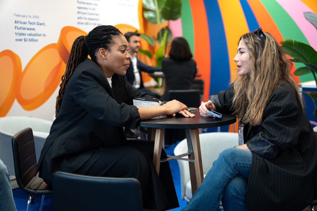 Flutterwave team member engaging with visitor at Money20/20 Europe booth